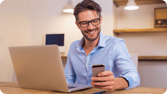 Homem olhando o celular em seu escritório