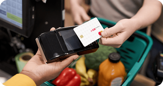 Cartão IOB Benefícios sendo usado no caixa de mercado